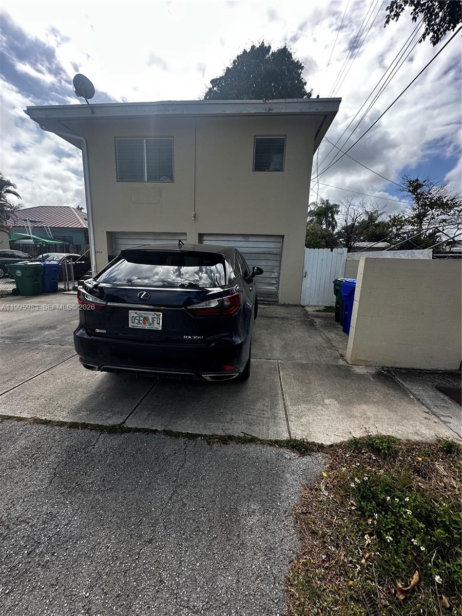 2420 Southwest 34th Avenue, Unit A Miami, FL 33145 - Photo 1 of 15 a view of a patio with table and chairs with wooden fence