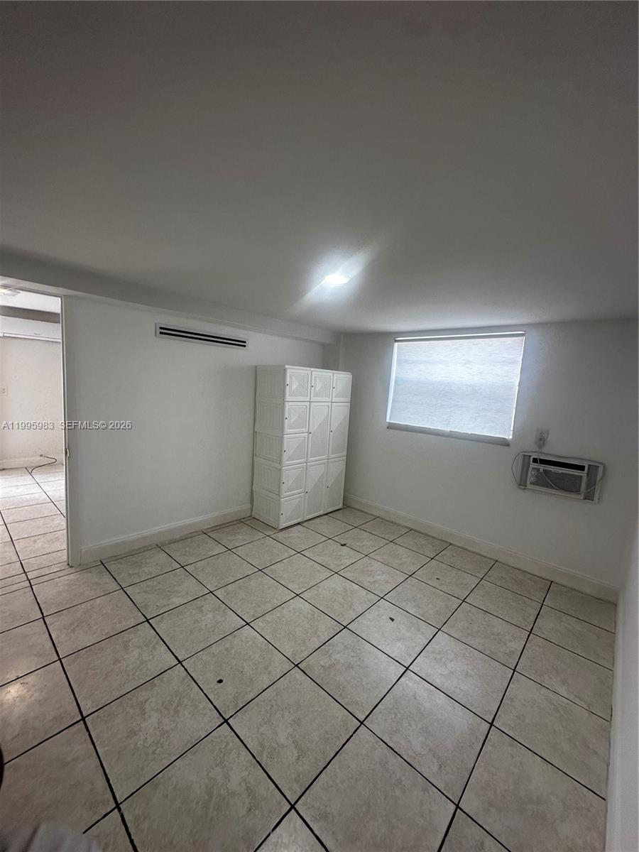 2420 Southwest 34th Avenue, Unit A Miami, FL 33145 - Photo 13 of 15 a view of an empty room and window