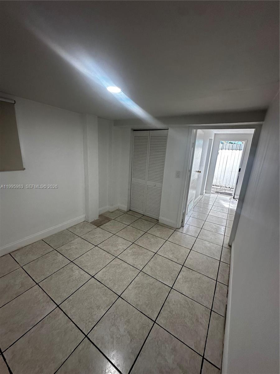2420 Southwest 34th Avenue, Unit A Miami, FL 33145 - Photo 7 of 15 a view of an empty room and a window
