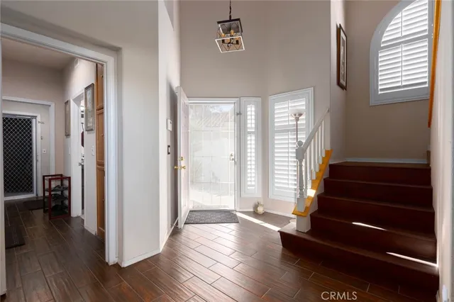 a view of a hallway with wooden floor and stairs