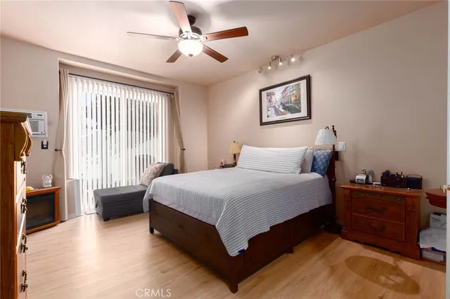 a spacious bedroom with a bed and a chandelier