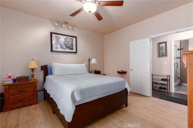a bedroom with bed and wooden floor