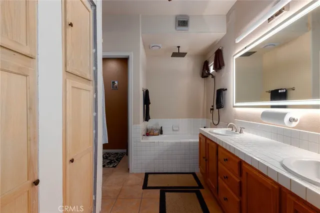 a bathroom with a sink double vanity and a mirror