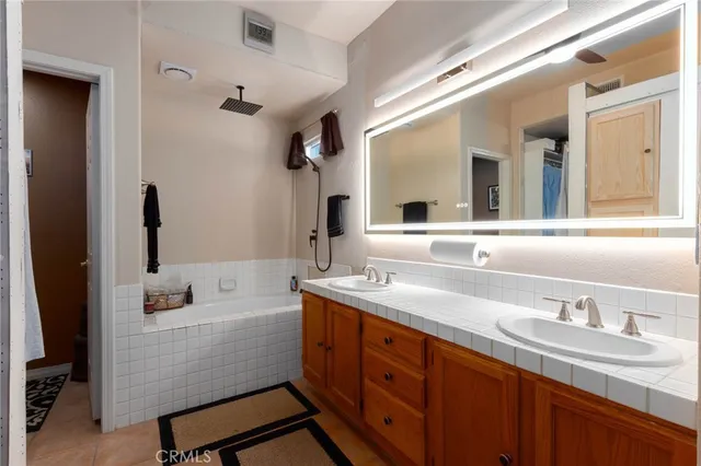 a bathroom with a granite countertop sink mirror and