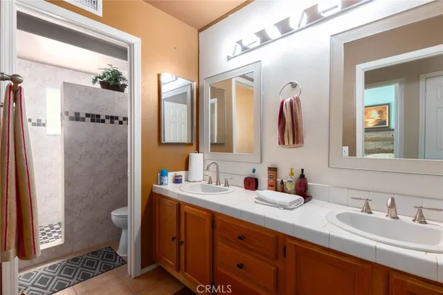 a bathroom with a double vanity sink and a mirror