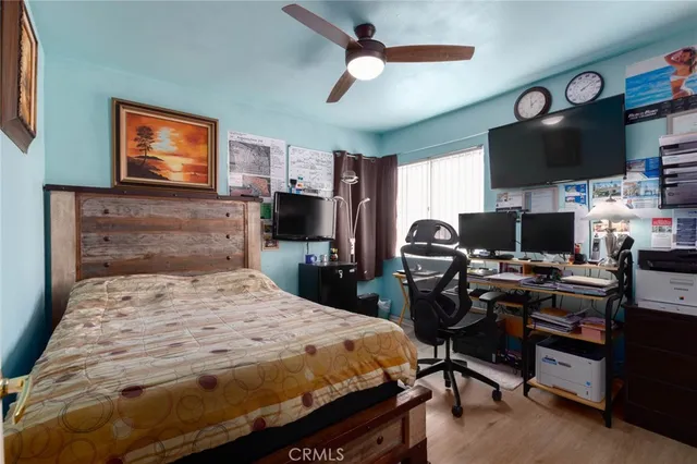 a bedroom with a bed and flat screen tv