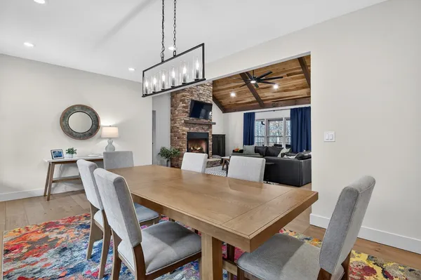 a dining room with furniture a rug and wooden floor