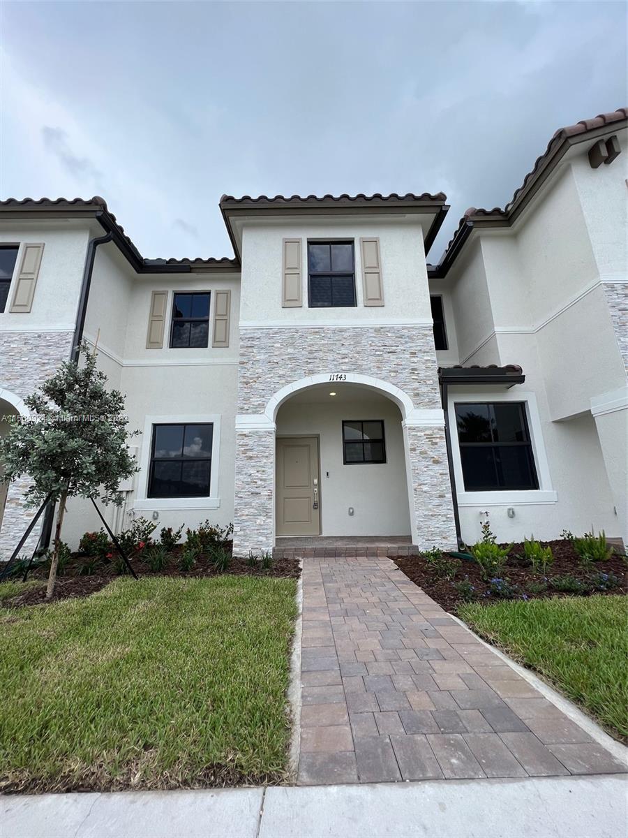 a front view of a house with a garden
