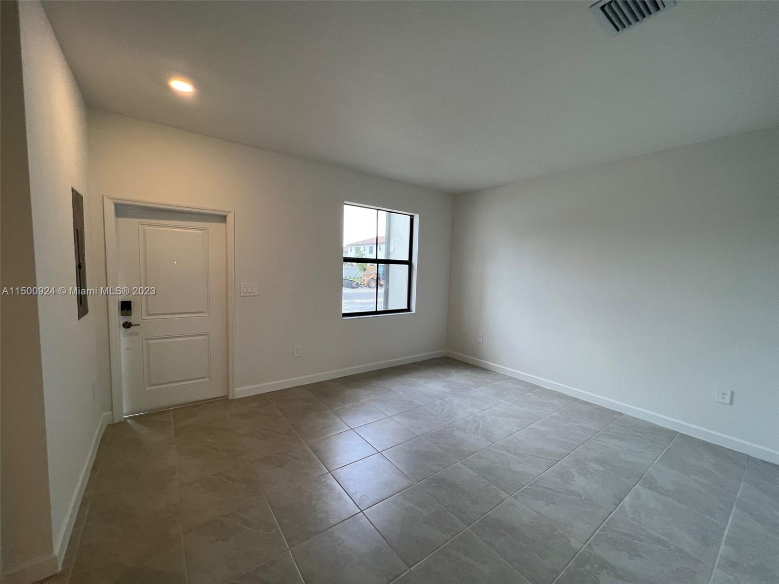 11743 Southwest 246th Terrace, Unit 11743 Homestead, FL 33032 - Photo 9 of 10 an empty room with windows and closet