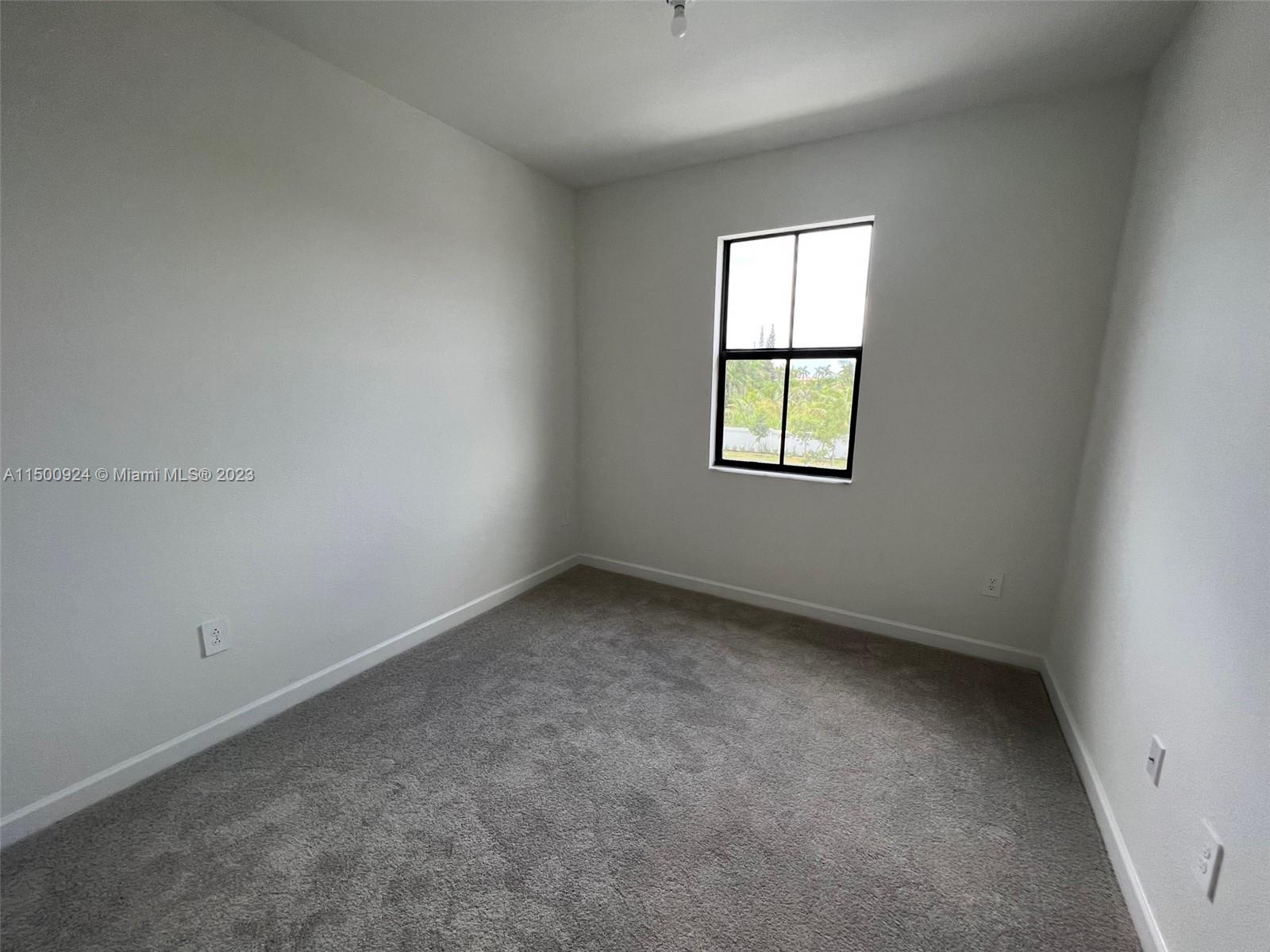 11743 Southwest 246th Terrace, Unit 11743 Homestead, FL 33032 - Photo 10 of 10 an empty room with a window