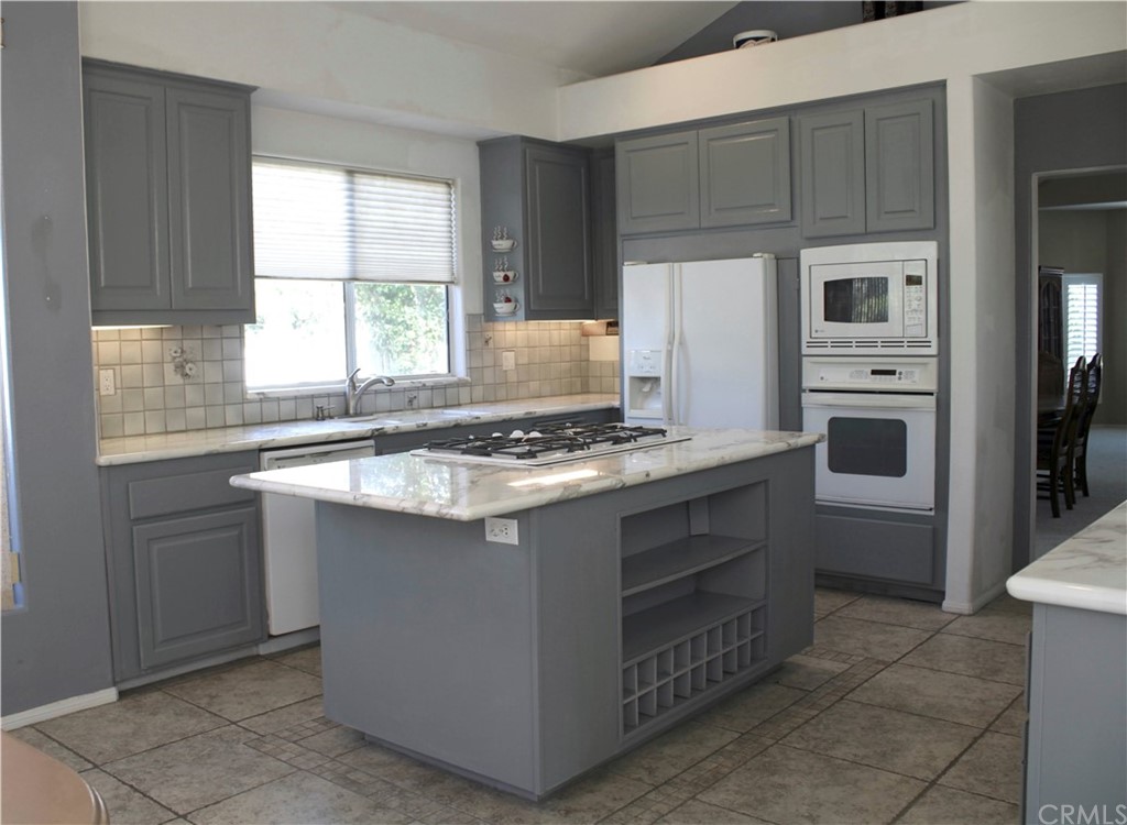 1299 Cll Sonia Fallbrook, CA 92028 - Photo 8 of 29 a kitchen with stainless steel appliances granite countertop a sink stove and refrigerator