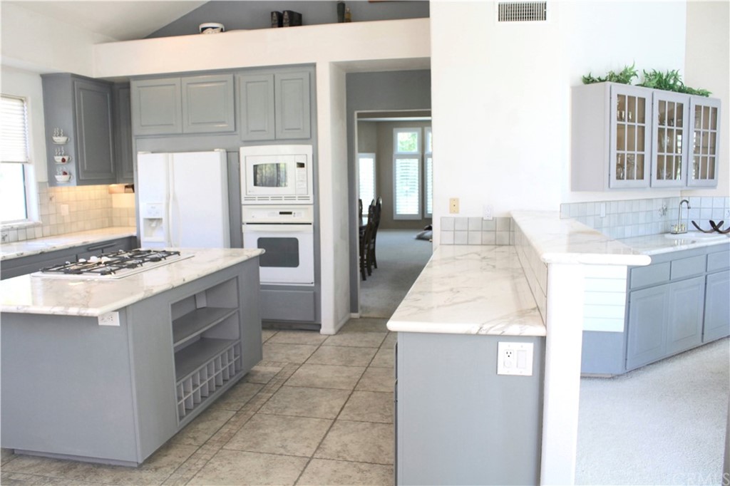 1299 Cll Sonia Fallbrook, CA 92028 - Photo 9 of 29 a kitchen with a sink stove and refrigerator