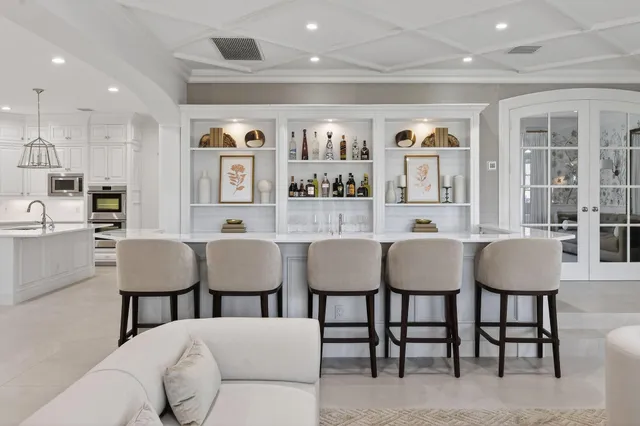 a kitchen with stainless steel appliances kitchen island granite countertop a sink a stove and cabinets