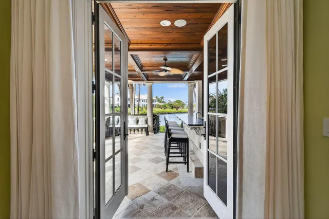 a hallway with wooden floor chandelier