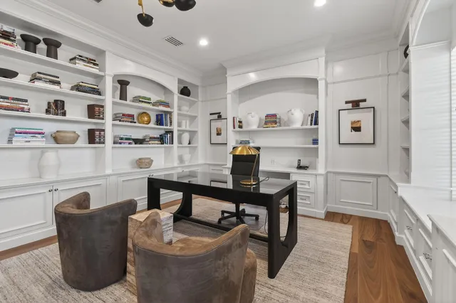 a bathroom with a tub a double vanity sink and a mirror