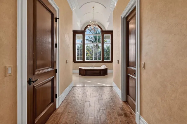 a spacious bedroom with a bed and large window