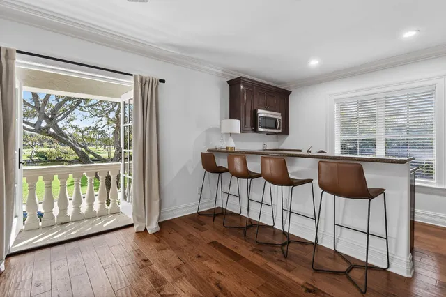a view of a lake with boats and palm trees
