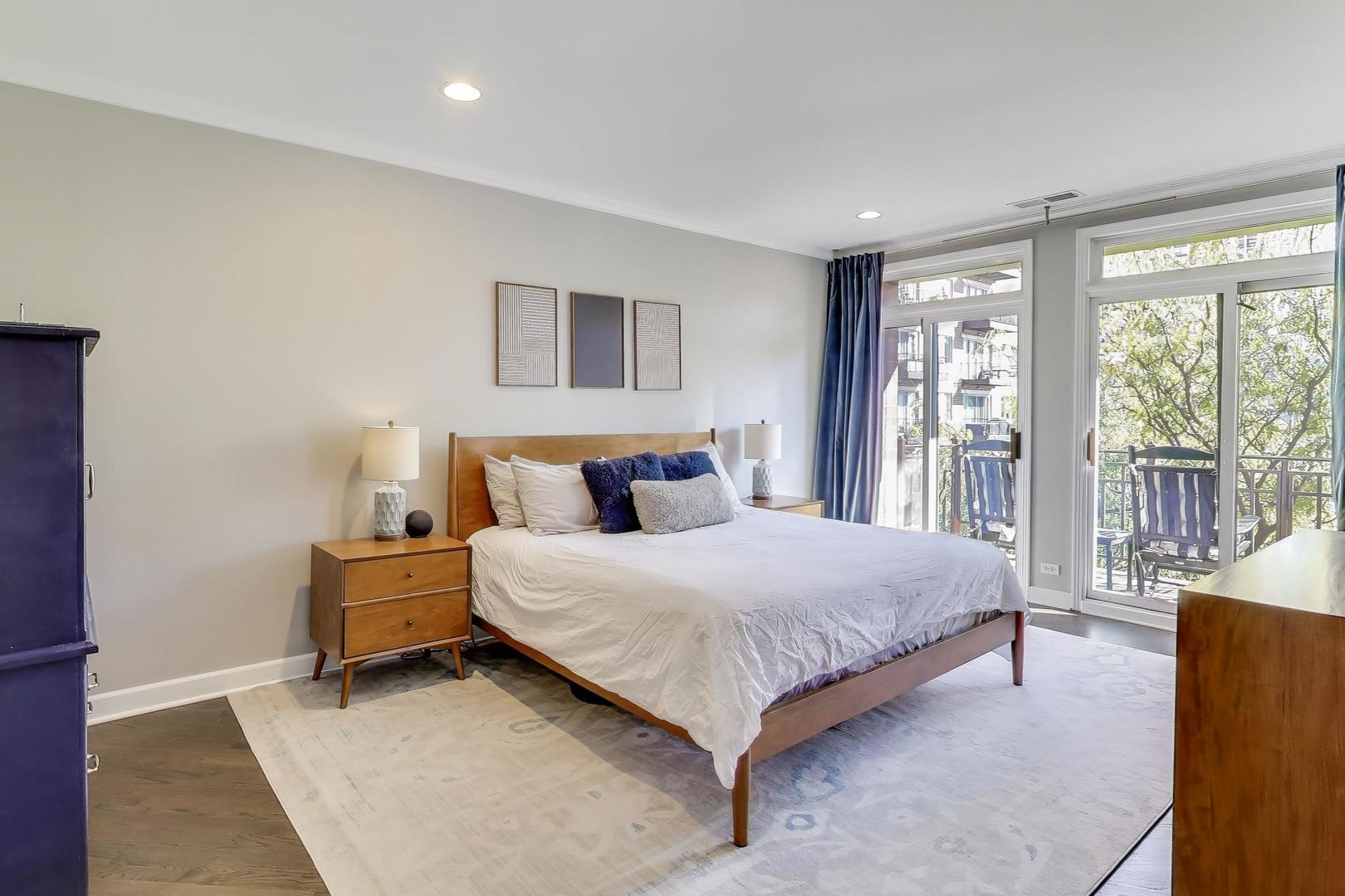 1414 North Wells Street, Unit 405 Chicago, IL 60610 - Photo 14 of 27 a bedroom with a bed and large window