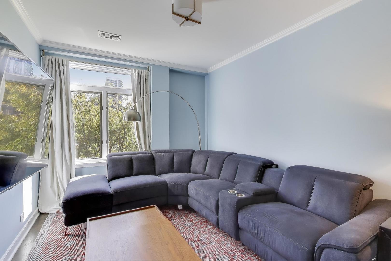 1414 North Wells Street, Unit 405 Chicago, IL 60610 - Photo 23 of 27 a living room with furniture and a large window