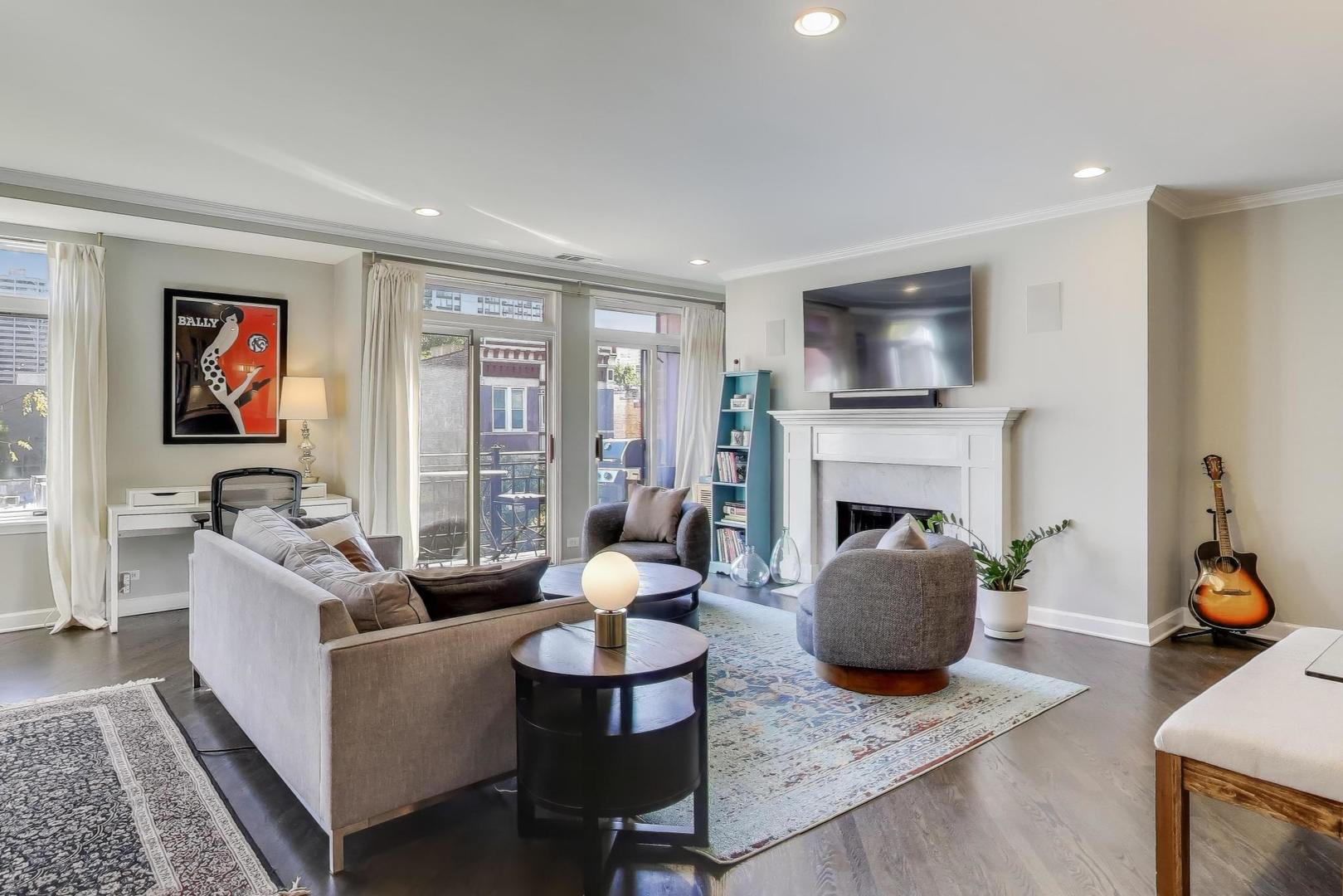 1414 North Wells Street, Unit 405 Chicago, IL 60610 - Photo 3 of 27 a living room with furniture a flat screen tv and a fireplace