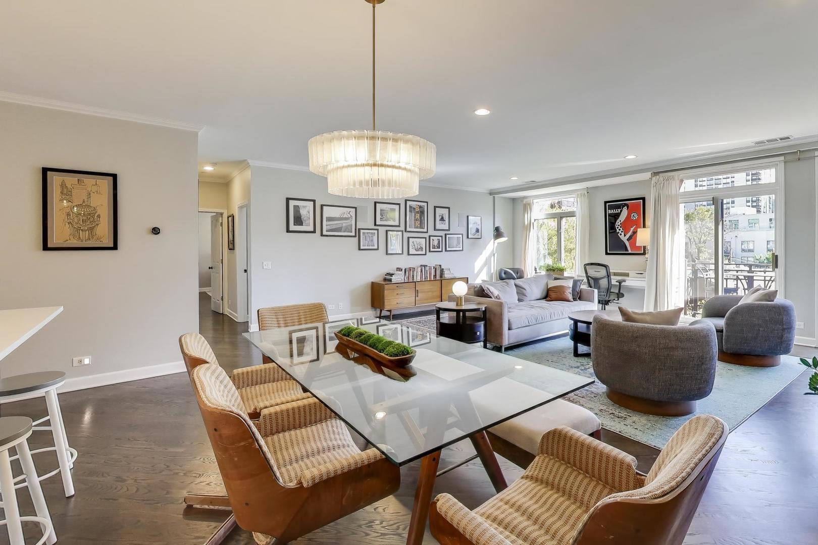 1414 North Wells Street, Unit 405 Chicago, IL 60610 - Photo 7 of 27 a living room with furniture a chandelier and a dining table