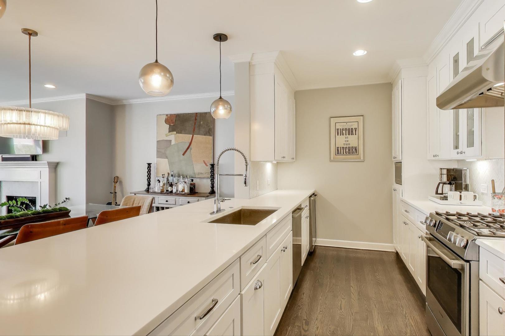 1414 North Wells Street, Unit 405 Chicago, IL 60610 - Photo 9 of 27 a kitchen with a sink stove and cabinets