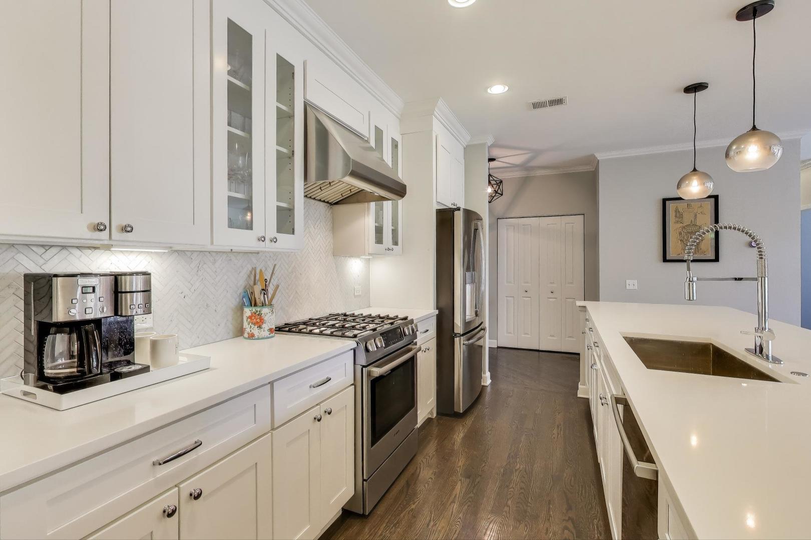 1414 North Wells Street, Unit 405 Chicago, IL 60610 - Photo 10 of 27 a kitchen with stainless steel appliances granite countertop a sink stove and refrigerator