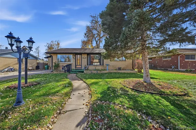 a front view of a house with a yard table and chairs