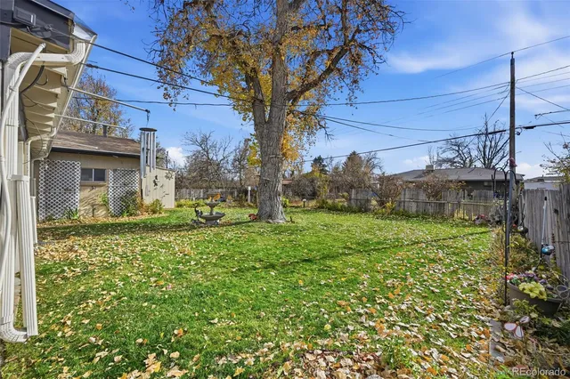 a view of a patio with table and chairs near a yard