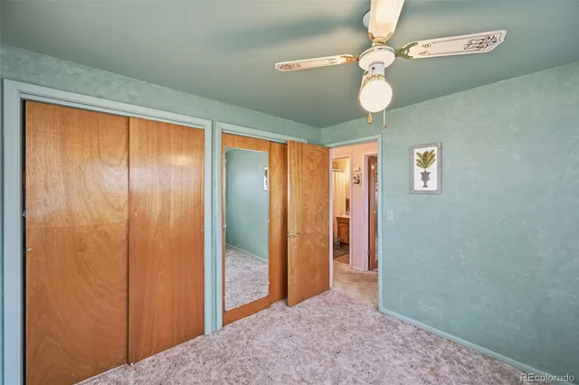 a view of a hallway with a chandelier fan