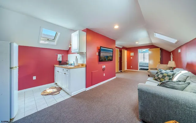 a living room with furniture and flat screen tv