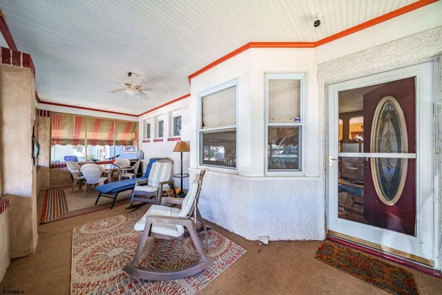 a living room with furniture a window and gym equipment