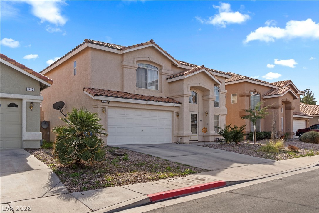 1419 Red Sunset Avenue Henderson, NV 89074 - Photo 2 of 35 Mediterranean / spanish-style home featuring stucco siding, a tile roof, and a garage