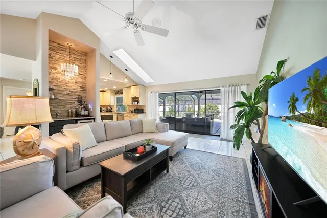 a living room with furniture and a potted plant