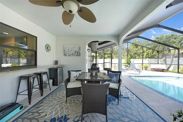 a dining room with furniture a chandelier and wooden floor