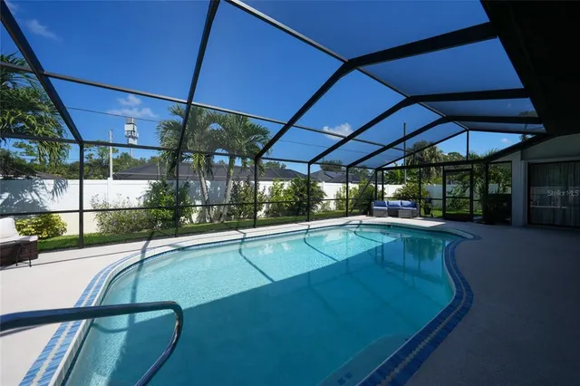 a view of a swimming pool with an outdoor seating