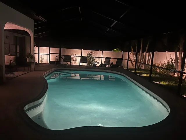 a spacious bedroom with a bed a couch and a window