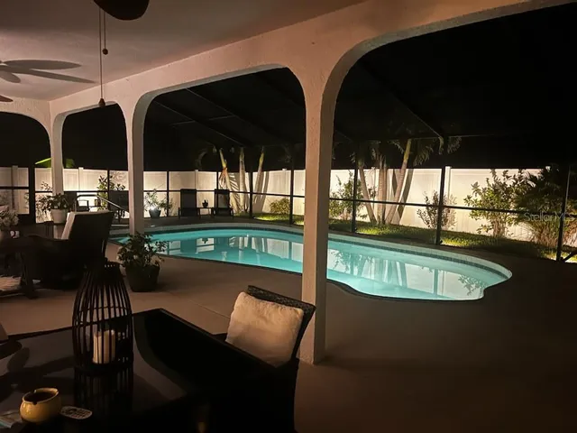 a spacious bedroom with a bed couch and window