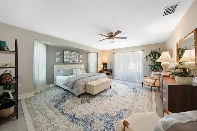 a spacious bathroom with a double vanity sink a toilet and a large mirror