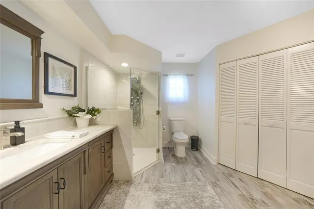 a bedroom with a large bed and a chandelier