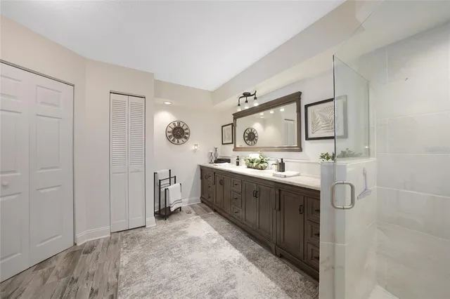 a bathroom with a tub a sink and a large mirror