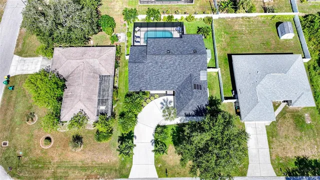 an aerial view of a house with a yard and garden