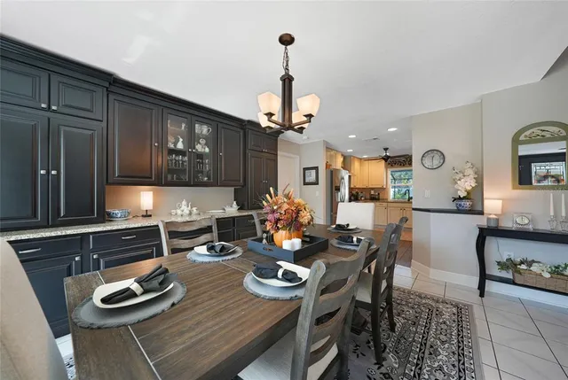 a kitchen with stainless steel appliances kitchen island granite countertop a dining table and chairs