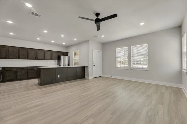 a view of living room with furniture and wooden floor