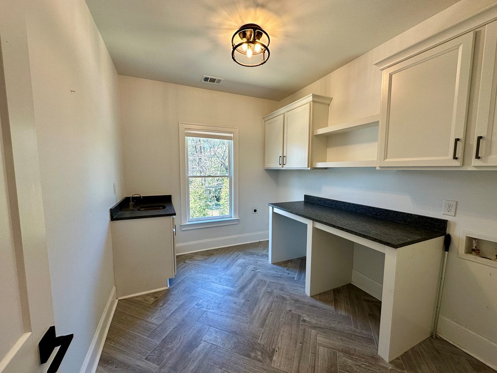 906 Winall Down Road Northeast Atlanta, GA 30319 - Photo 74 of 87 a kitchen with granite countertop a stove a sink and a microwave
