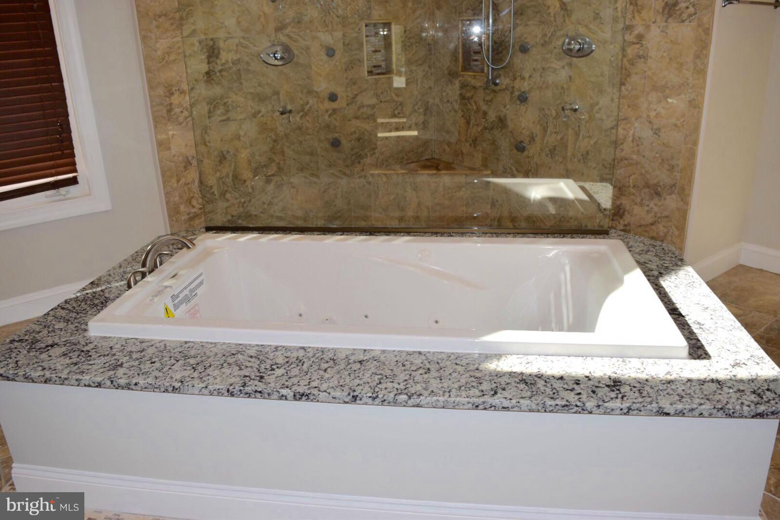 13901 Candy Hill Road Upper Marlboro, MD 20772 - Photo 14 of 20 a bathroom with a granite countertop sink and bathtub