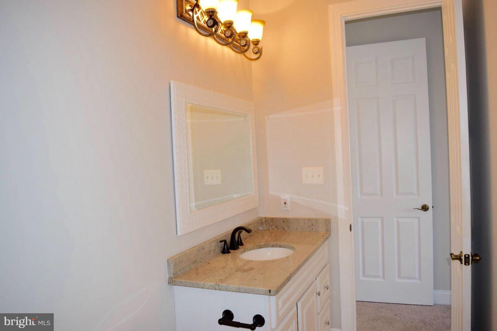 13901 Candy Hill Road Upper Marlboro, MD 20772 - Photo 18 of 20 a bathroom with a sink and a mirror
