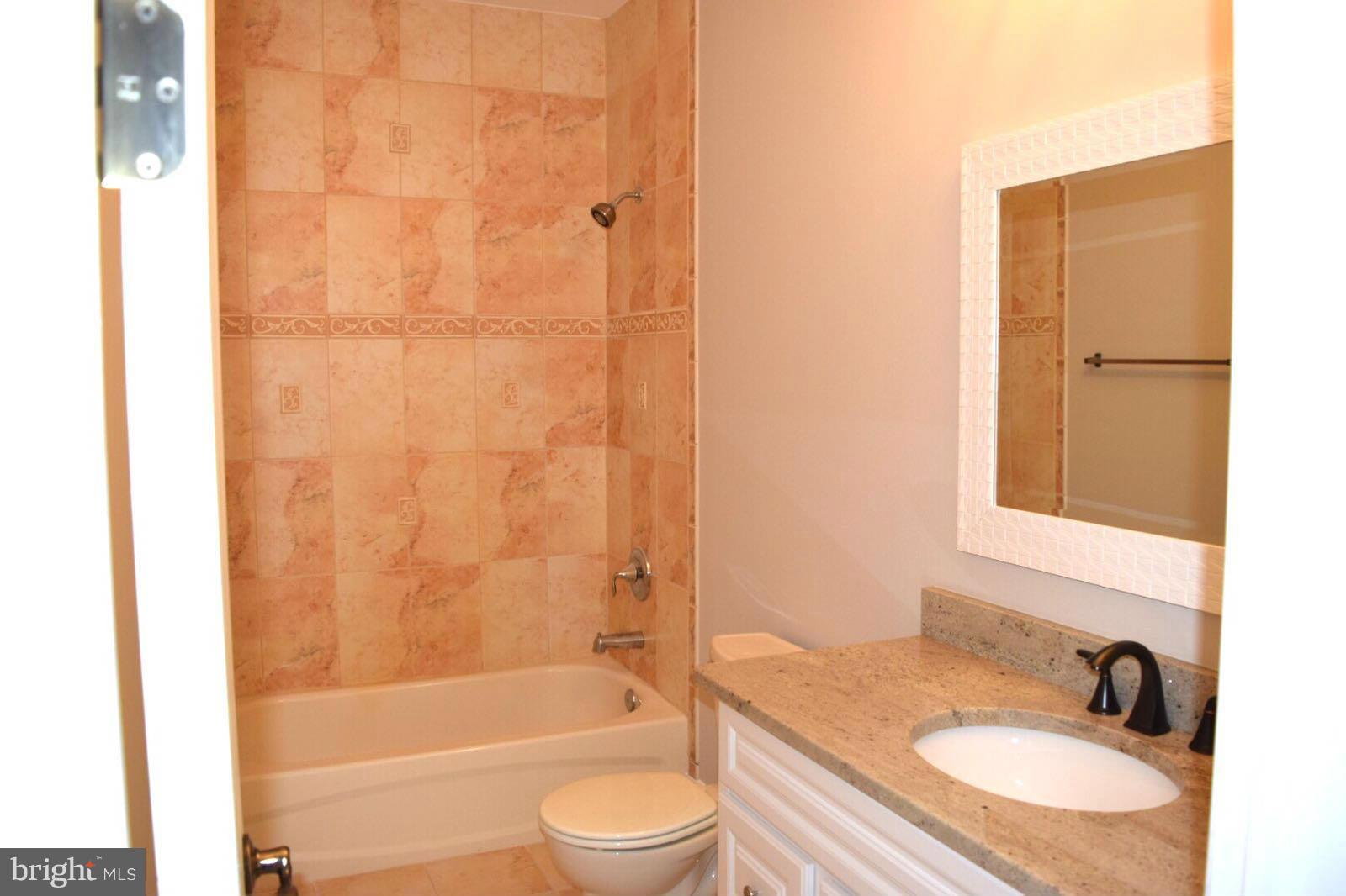13901 Candy Hill Road Upper Marlboro, MD 20772 - Photo 20 of 20 a bathroom with a granite countertop sink toilet and shower