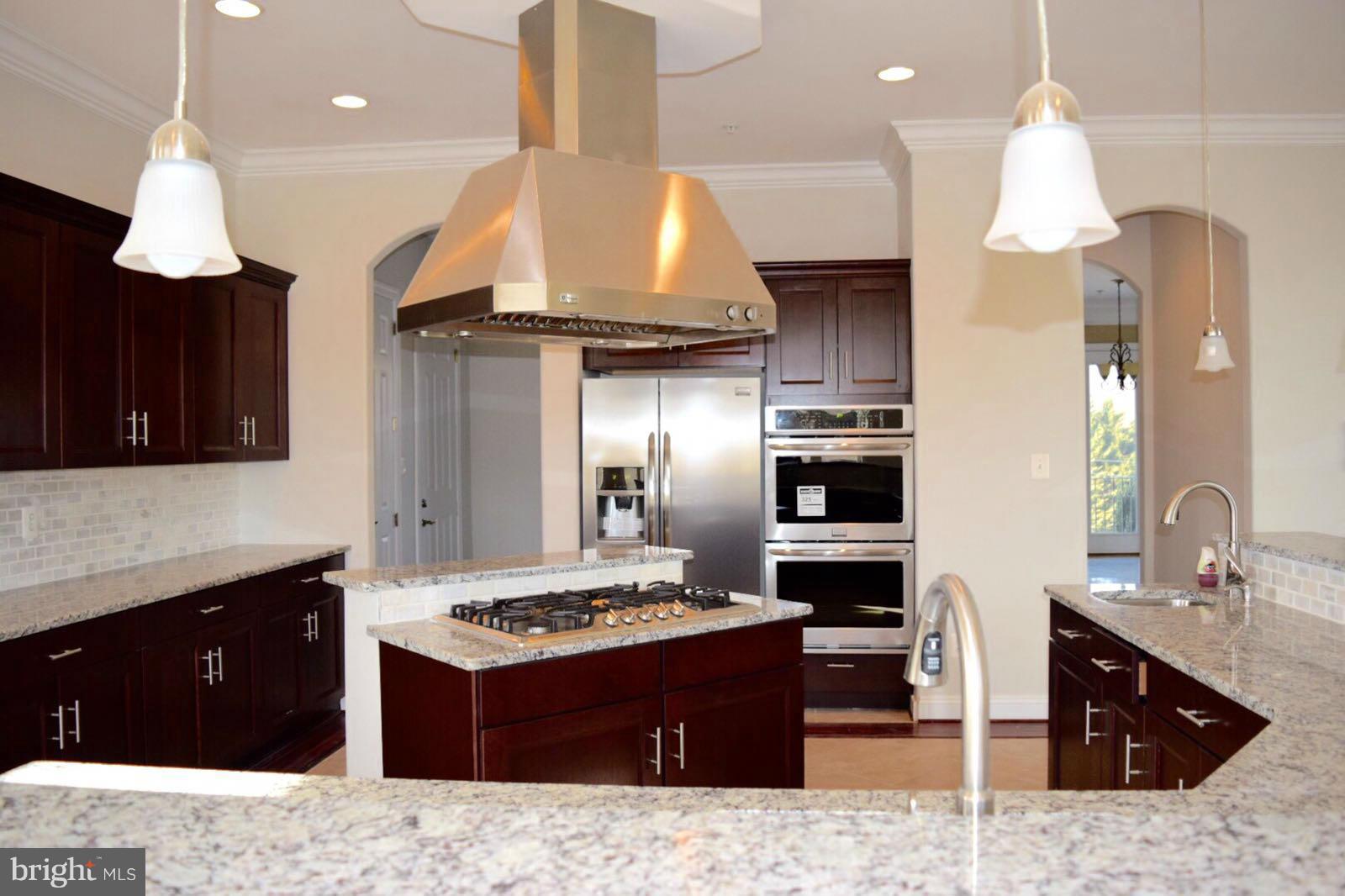 13901 Candy Hill Road Upper Marlboro, MD 20772 - Photo 5 of 20 a large kitchen with granite countertop a stove refrigerator and a sink