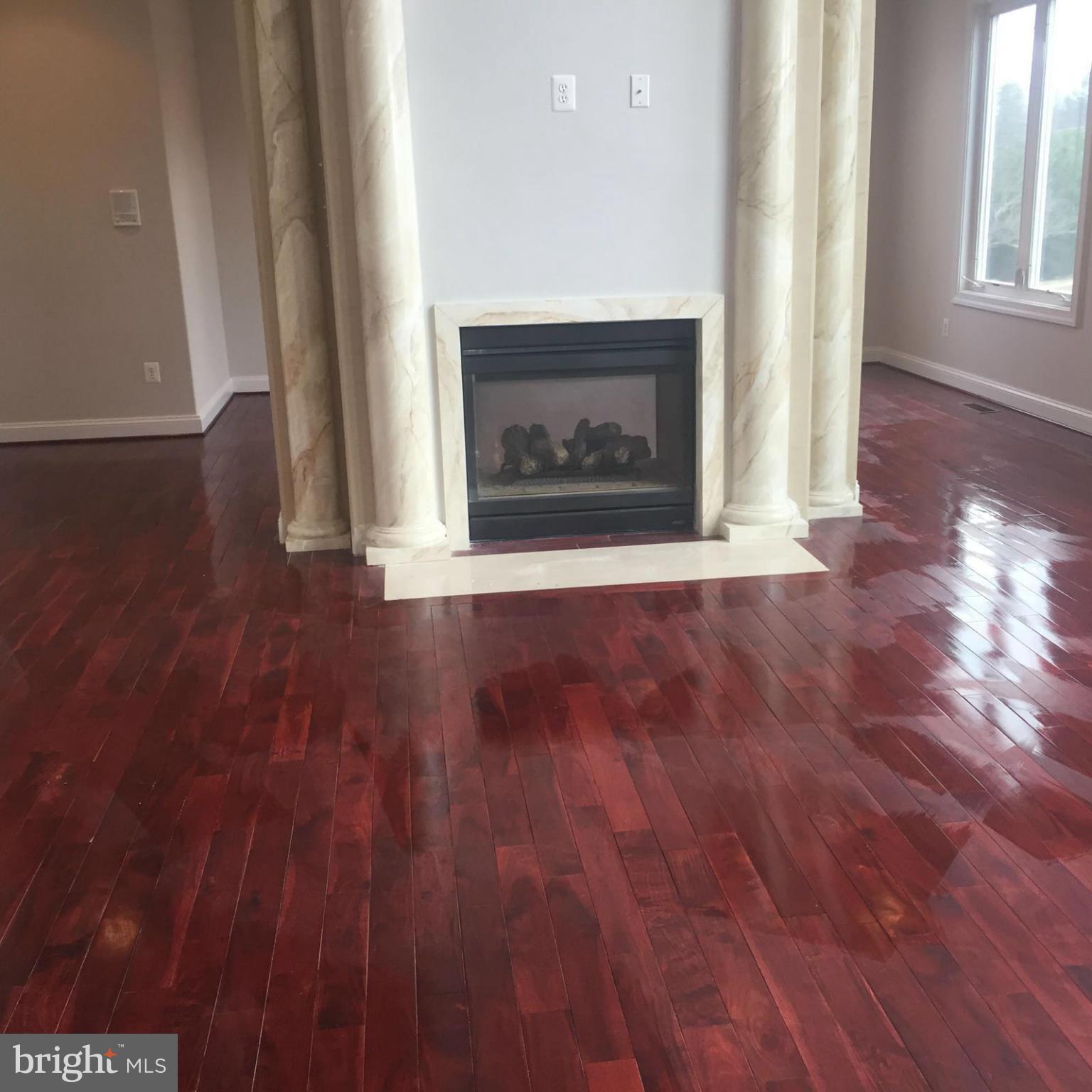 13901 Candy Hill Road Upper Marlboro, MD 20772 - Photo 7 of 20 a view of an empty room with wooden floor and a window